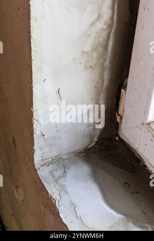 first layers of fresh plaster in corner of window sill close up Stock Photo