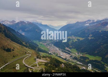 The winding road of Gotthard Pass in the Swiss Alps, coming through the town of Airolo Stock Photo