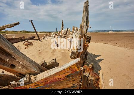 A wrecked boat on sand flats at Crow Point, in the Taw and Torridge estuary, near Banrnsaple, Devon, Great Britain. Stock Photo