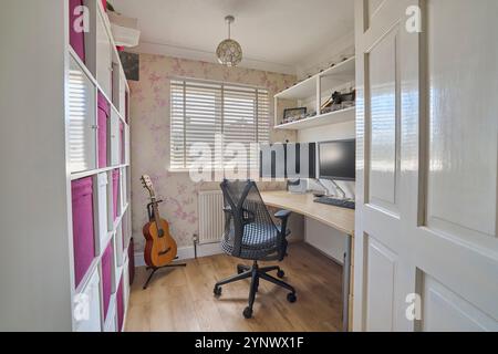 Interior Of House Showing Home Office With Computer Desk And Storage Stock Photo