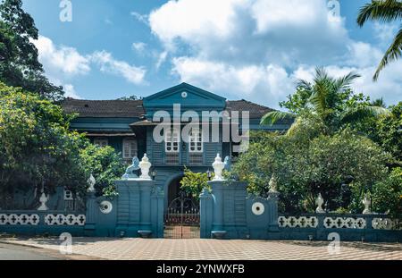 A beautiful front view of a heritage building built in Portuguese style. Vintage colonial houses built in Portuguese style in Goa, India. A brightly c Stock Photo