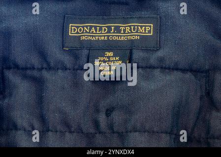 NEW ORLEANS, LA, USA - SEPTEMBER 27, 2024: Closeup of gold label inside pair of black pants that reads 'Donald J. Trump  Signature Collection,' and size '36,' '70% Silk,' '30% Cotton,' 'Made in China' Stock Photo