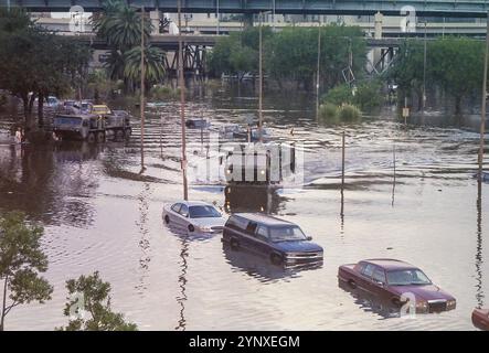 New Orleans, LA, USA - August, 2005: A large military truck drives through the flooded street past the Superdome after levee failures flooded much of the City in the aftermath of Hurricane Katrina. Parked cars line the flooded street. Stock Photo