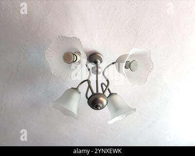 Old white chandelier with four modern LED lamps Stock Photo
