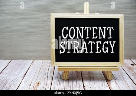 Content Strategy text written on chalkboard with easel on wooden background Stock Photo
