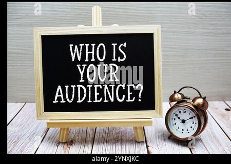 Who is your audience? text written on chalkboard with alarm clock on wooden background Stock Photo