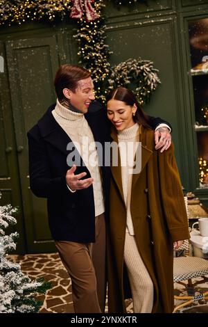 A loving couple embraces warmly, enjoying each other in a charming winter ambiance. Stock Photo