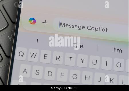 New York, USA - November 26, 2024: Entering promt to Copilot AI menu on screen in keyboard button background close up view Stock Photo