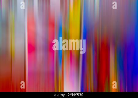 Vertical streaks of vibrant colors blend together, creating a sense of movement and depth. The composition includes a mix of reds, yellows, blues Stock Photo