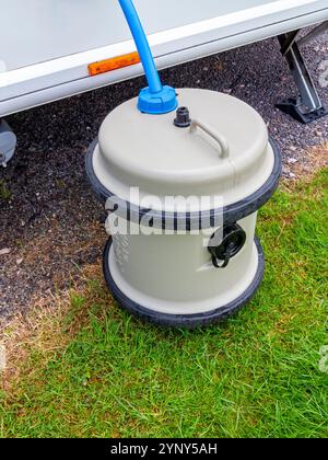 Aqua Roll water supply system connected to a touring caravan on a caravan site with Truma hose and pump. Stock Photo