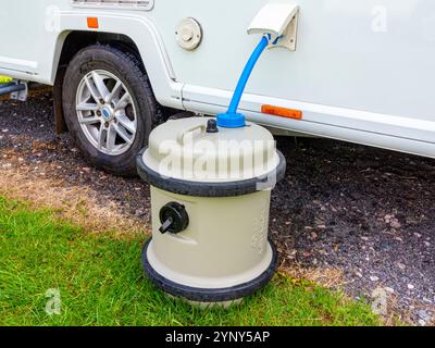 Aqua Roll water supply system connected to a touring caravan on a caravan site with Truma hose and pump. Stock Photo