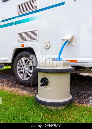 Aqua Roll water supply system connected to a touring caravan on a caravan site with Truma hose and pump. Stock Photo