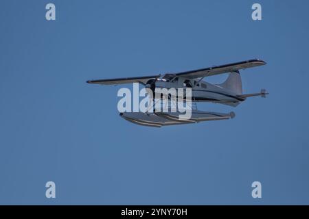 Seaplane in flight against a blue sky, British Columbia, Canada Stock Photo