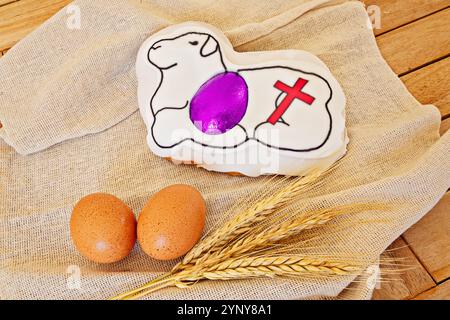 Easter lamb cake with symbolic cross and eggs on burlap cloth Stock Photo