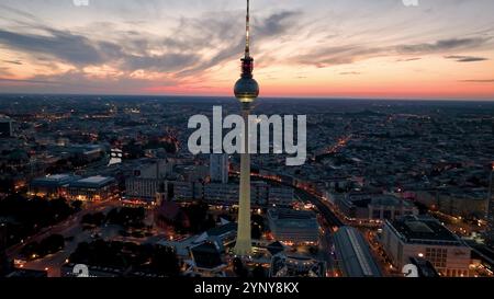 Aerial video shows a vibrant cityscape with a majestic tower famous places architectural landmarks TV Tower, Alexanderplatz at night. Berlin, Germany Stock Photo