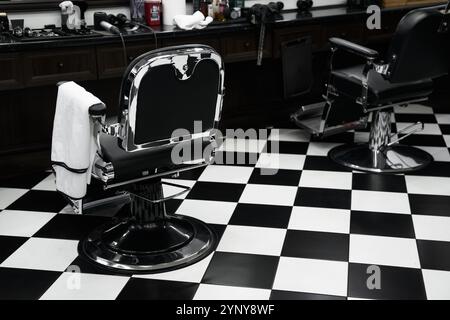 Vintage barber chairs and checkered floor in a classic barbershop ...