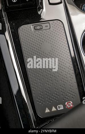 Modern car wireless smartphone inductive charger pad Stock Photo