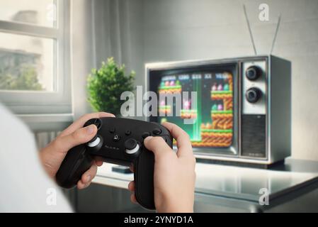 Player using a gamepad to play a platformer on a retro TV, showcasing the concept of classic gaming and nostalgic entertainment Stock Photo