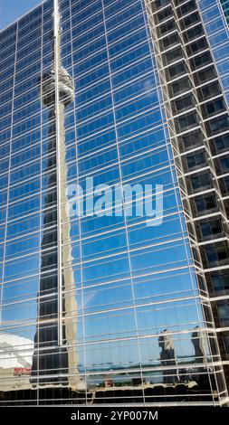 Reflection of the CN Tower in Toronto, Ontario on an adjacent building on a clear sunny day Stock Photo