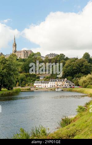 A view of the church of Saint Julien from the Nantes-Brest canal in Châteauneuf-du-Faou, France Stock Photo