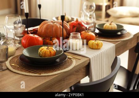 Stylish table setting with beautiful autumn decor in dining room Stock Photo