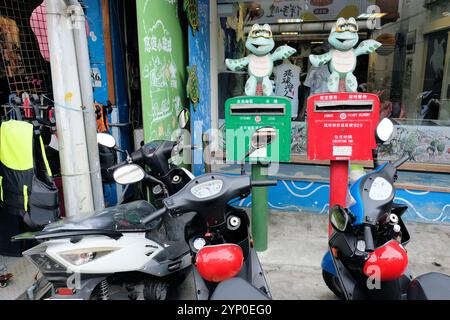 Pair of red and green mailboxes with iconic local turtle characters on the island of Xiao Liuqiu, Pingtung County, Taiwan; local, outgoing letterboxes Stock Photo