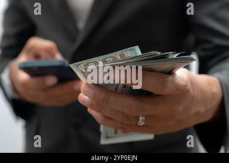 Man hand with a stack of hundred US dollars bills Stock Photo
