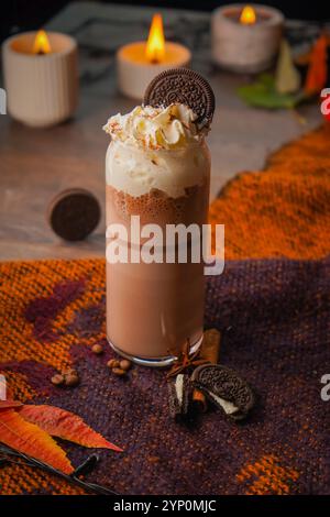 Homemade milkshake (chocolate smoothie) with cookies on rustic wooden table close up Stock Photo