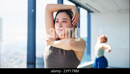 Fitness, woman and creative performance for practice, training and choreography in ballet dance studio. Rehearsal, flexibility and Japanese dancer for Stock Photo