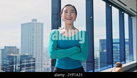 Portrait, Japanese woman and arms crossed in dance studio for practice, training and choreography in ballet. Confidence, pride and professional dancer Stock Photo