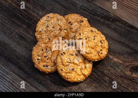Heart shaped cookies on wooden table, sweet homemade Heart-shaped cookies with oat flakes. Oatmeal cookies with sesame seeds. oatmeal cookies with see Stock Photo
