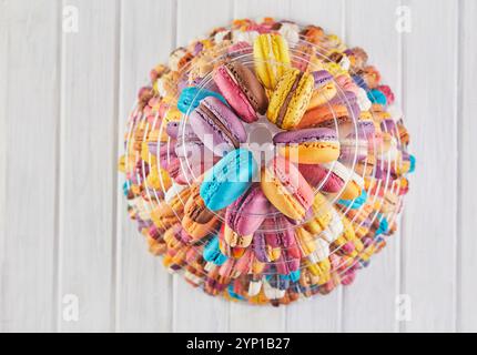 A top-down view of colorful macarons arranged in a circular pattern, showcasing their delicate textures and pastel hues. Stock Photo