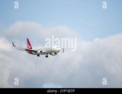 Auckland, New Zealand - November 24 2024: Qantas Airlines Boeing 737 flying towards Auckland International Airport. Stock Photo