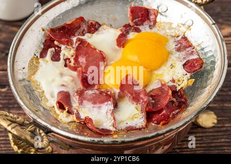 Traditional Turkish breakfast eggs with fried pastrami or bacon. Turkish name Pastirmali yumurta Stock Photo