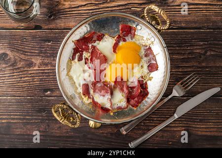 Traditional Turkish breakfast eggs with fried pastrami or bacon. Turkish name Pastirmali yumurta Stock Photo