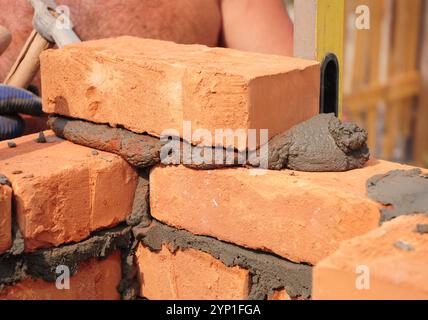 Close up on bricklayer laying bricks. Stock Photo