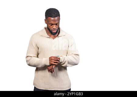 Stylish young man looking at his wristwatch, seemingly checking the time Stock Photo