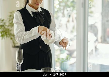 Cleaning Wine Glass in Elegant Dining Setting Stock Photo