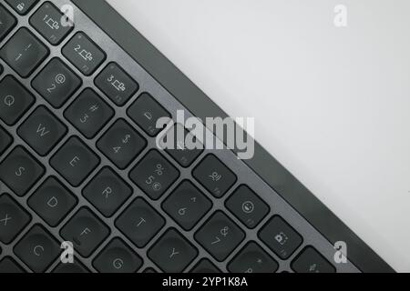 a closeup of a black wireless bluetooth keyboard isolated on white background Stock Photo