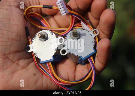 Stepper motor used in making robots and in other electronics held in the hand Stock Photo
