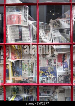 shop window blanked out with old newspapers norwich norfolk england Stock Photo