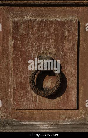 Antique cast iron door knocker on the old wooden door of a wooden Turkish House, close up Stock Photo