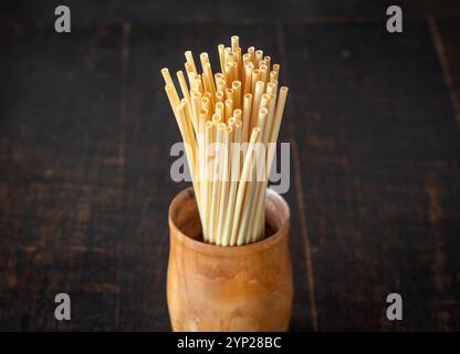 Many biodegradable wheat straws in a wooden cup Stock Photo