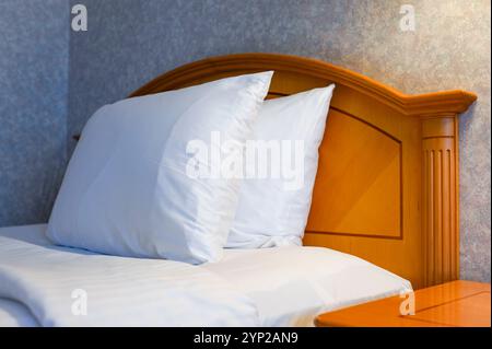 Two white pillows on bed in living room Stock Photo