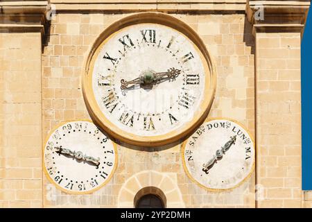 Antique dilapidated clock and calendar on the facade of St. John's Co-Cathedral in Valletta, Malta Stock Photo