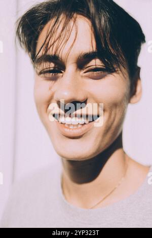 Portrait of happy young man at sunny day Stock Photo