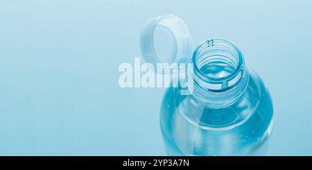 Close up of new cap attached to plastic bottle, connected to the neck of the bottle by solid tab attached to safety ring. They are intended to encoura Stock Photo