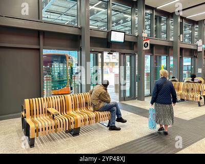 Cardiff, Wales - 24 July 2024: People inside the new bus station in Cardiff city centre Stock Photo