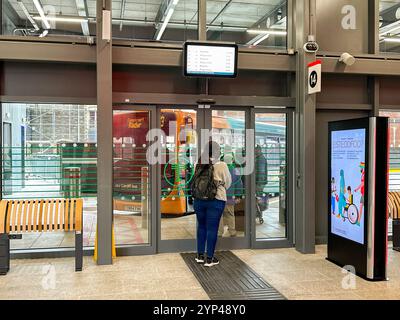 Cardiff, Wales - 24 July 2024: People waiting to board a bus at the new bus station in Cardiff city centre Stock Photo