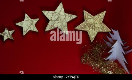 Golden stars on a red background. Christmas decoration. Stock Photo